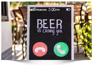 chalk sign with words beer is calling you